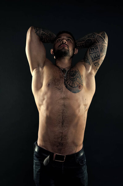 I am perfect. Tattoo man with sexy bare torso. Bearded macho with tattooed body. Athlete with sexy bare torso. Sportsman with muscular chest and belly. Sport and fitness. Narcissism. Self care