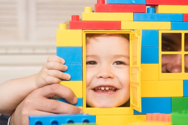 Father and son looking through door and window of construction. — Stock Photo, Image