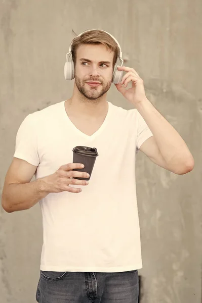 Casque stéréo pliable. Réduction du bruit. Musique moderne et contemporaine. Ecouteur sans fil. Le beau mec porte des écouteurs fond gris. Homme étudiant écouter de la musique moderne. Technologie moderne — Photo