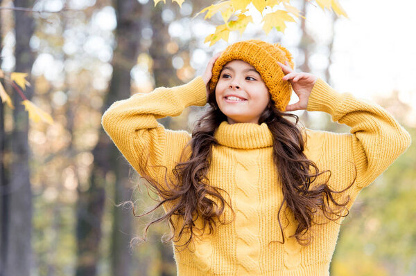 pretty girl wear yellow knitted sweater and hat, autumn