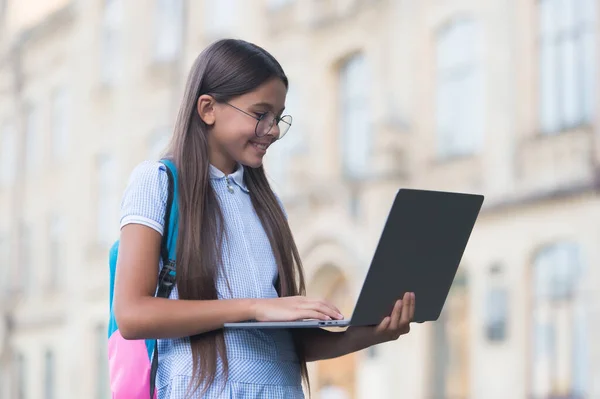 schoolgirl kid study in park does school homework, Distance learning online education