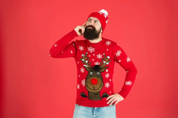 What to do. Need inspiration. New year concept. Join winter holiday party. Christmas Party. Winter outfit. Hipster emotional bearded man wear winter sweater and hat red background. Consequence — Stock Photo, Image