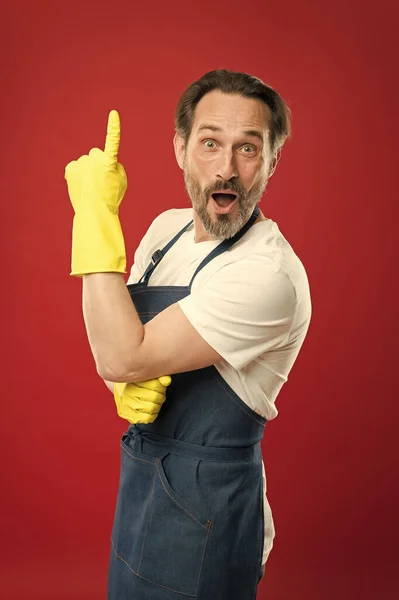 Idea for easy cleaning. Bearded guy cleaning home. Bearded worker. On guard of cleanliness. Cleaning service and household duty. Lot of work. Man in apron with gloves. Cleaning day today