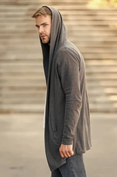 hooligan wear hoodie. looking like thief in hooded cardigan. Casual style. concept of danger and confidence. Urban fashion look. city modern life. man in hoody. man in hood outdoor. Hip and stylish