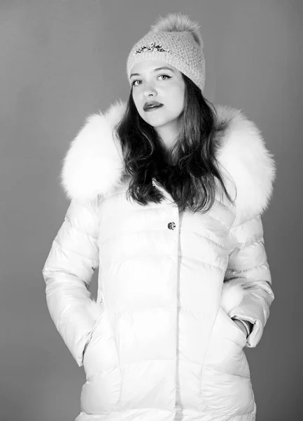 Woman wear down jacket. Style code with elegance. For those wishing stay modern. Winter clothes. Warm and cozy. Girl wear winter jacket blue background. Fashion trend. Winter season of contrasts