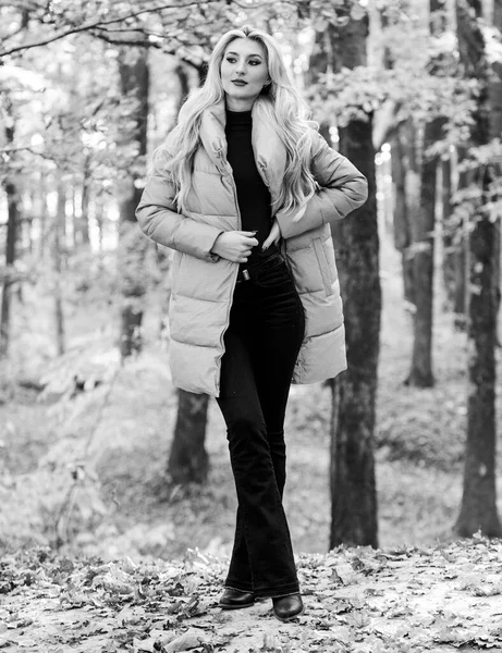 Outfit prove puffer coat can look stylish. Girl fashionable blonde walk in park. Jackets everyone should have. Best puffer coats to buy. How to rock puffer jacket like star. Puffer fashion concept