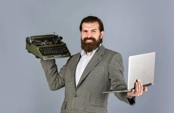 my choice. bearded man in jacket with retro type writer. new technology in modern life. Man working on retro typewriter in library. mechanical vs digital. writer writes with typewriter and laptop