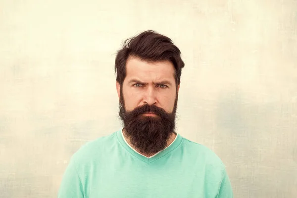 Strict face. Perceptions of male beauty around the world. Man bearded hipster stylish beard grey background. Stylish beard and mustache care. Hipster appearance. Beard fashion and barber concept — Stock Photo, Image
