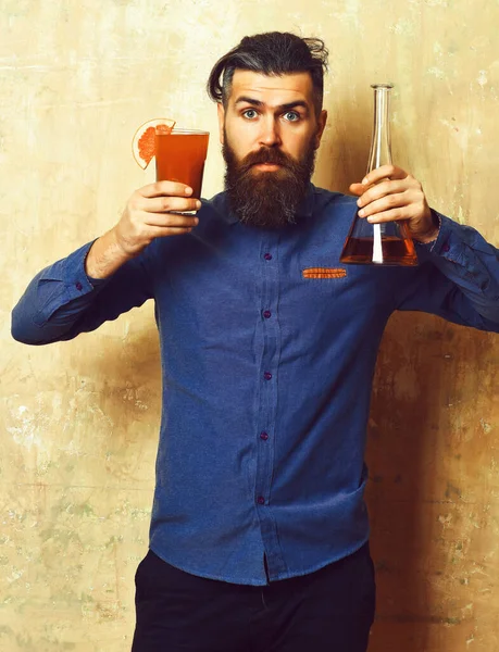 Brutal hipster holding alcoholic shot and glass tube or flask — Stock Photo, Image
