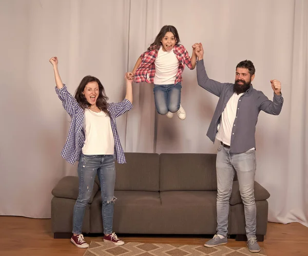 Higher. Friendly family jump couch Mom dad and daughter relaxing. We are family. Happy family spend weekend together. Our home made for fun. Togetherness and bonds. Good vibes. Positive emotions