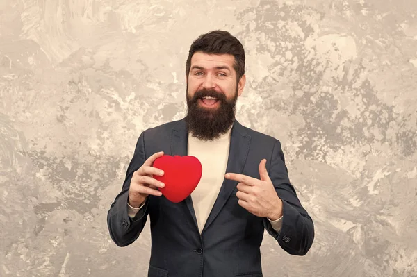 Give your heart for Valentines day. Organ donation. Bearded man point finger at red heart. Heart problem or attack. Heartache. Chest pain. Health and care. Healthcare. Have heart, donate life