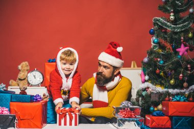 Sakallı ve neşeli yüzlü bir adam oğluyla oynuyor..