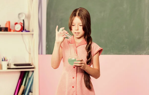 Fascinating lesson. Small girl with chemical tube. Biology education. Girl chemistry class testing tube. Chemical reaction. Chemical liquid. Science lesson. School laboratory. Scientific experiment