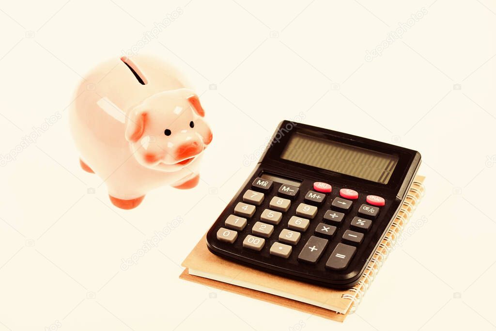 Piggy bank pink pig and calculator. Exchange rates. Economics and business administration. Credit debt concept. Piggy bank money savings. Economics and profit management. Economics and finance