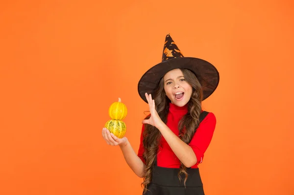 Magic. kid cast spell on pumpkin. child celebrate autumn holiday. teenage girl in witch hat celebrate halloween. happy halloween. trick or treat concept. carnival festive costume of witch — Stock Photo, Image