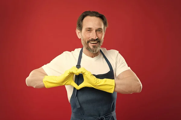 My heart belongs to cleanliness. On guard of cleanliness. Cleaning service and household duty. Lot of work. Man in apron with gloves cleaning. Cleaning day today. Guy cleaning home. Bearded worker — Stock Photo, Image