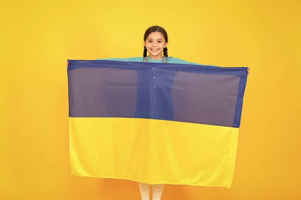 I am ukrainian and proud of it. Patriotism love Ukraine motherland. National identity. Girl with blue and yellow ukrainian flag. Patriotic education. Happy independence day. Kid hold ukrainian flag — Stock Photo, Image