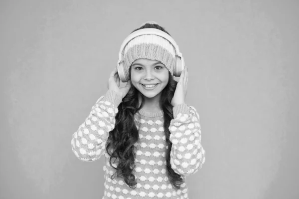 Favorite band. Girl long hair listen music headphones. Hobby concept. Winter holidays. Winter music chart. Winter playlist. Entertain herself. Recording studio. Beautiful voice. Developing voice