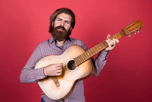 Practicing. handsome man singer and guitarist. acoustic guitar player. mature hipster musician with beard. brutal caucasian guy playing guitar. country music. bearded man singing song — Stock Photo, Image