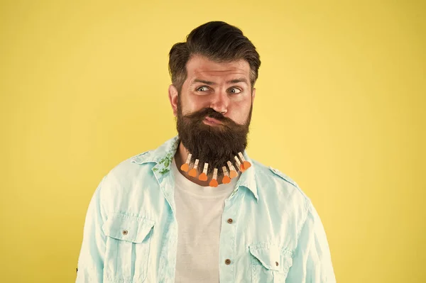 Irritated skin. Balm and lotion. Grooming standards. Skin care. Barber tips. Growing long beard. Man with beard and clothespins. Decor and accessory. Beard styling product. Annoying feeling — Stock Photo, Image