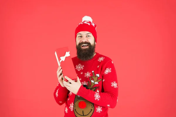 Buy thing from wish list. Christmas gift. Guy wear winter hat. Merry christmas and happy new year. Handsome man celebrate winter holidays red background. Christmas shopping. Christmas present concept