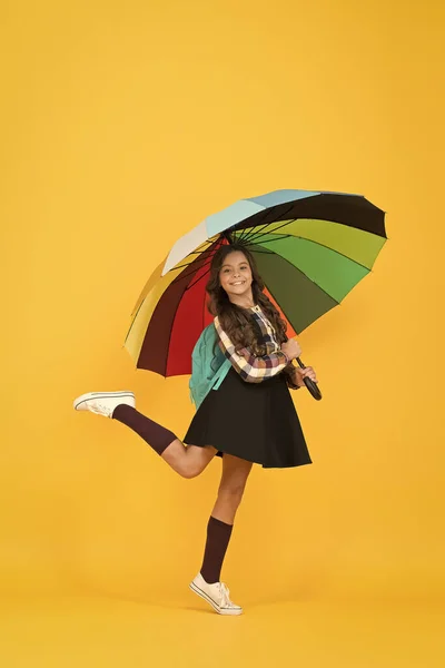 Trendy beauty. positive mood. happy child protected rain. dance bad weather away. color up life. school time. good weather forecast. under my umbrella. small girl colorful umbrella. autumn style