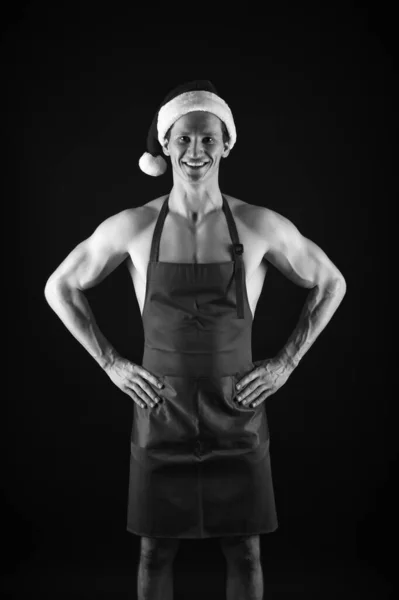 Let me cook for you. Muscular man wear santa claus hat. Bodybuilder on black background. Winter holidays. Muscular sportsman celebrate new year. Christmas spirit. Christmas tradition. Merry christmas