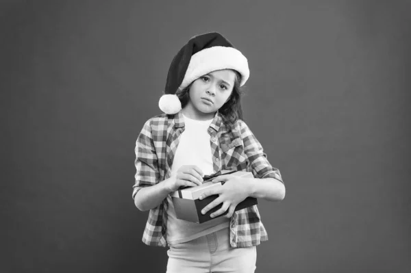 Best gift for xmas. unhappy little girl open present box. happy new year gift. time for christmas holiday presents. small girl in santa hat. sad child red background. christmas kid shopping — Stock Photo, Image