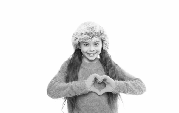 Love in heart. happy little kid isolated on white. ready for winter cold. small girl earflap hat and gloves. her favorite knitted sweater. active healthy childhood. autumn style look. kid fashion — Stock Photo, Image