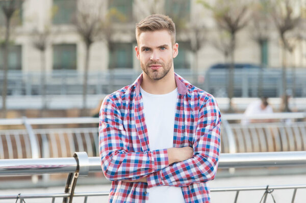 Confident in his choice. casual dressed person relax in city outdoor. Caucasian male resting in street. modern life concept. Young man in checkered shirt. businessman standing outdoor