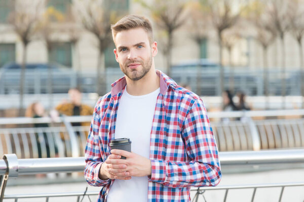 unshaven guy with bristle wear checkered shirt drink mooring coffee cup in street, lifestyle concept