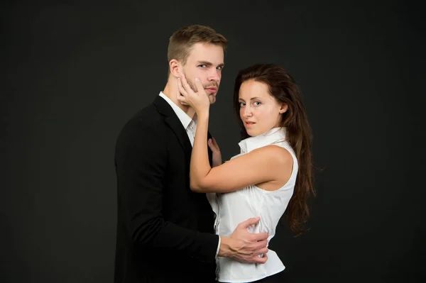 Young couple is hugging each other. attractive girl with handsome man in passionate pose. impassioned girl caresses businesslike guy. sensual relationship. elegant people in classic clothes — Stock Photo, Image