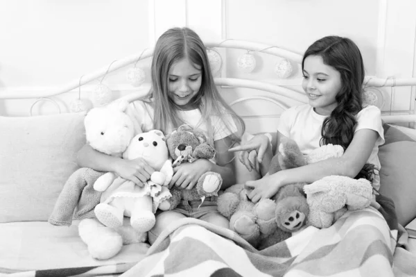 Best friends forever. Adorable friends play with toys. Small friends enjoy friendship. Little friends in bedroom. Happy childhood. Leisure and playtime. Playing games