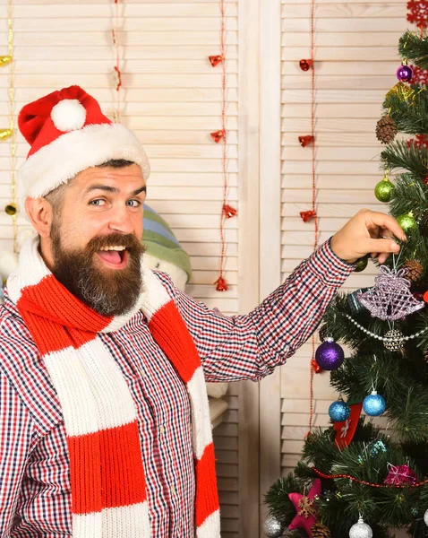 Man with beard holds purple tree decoration. — Stock Photo, Image