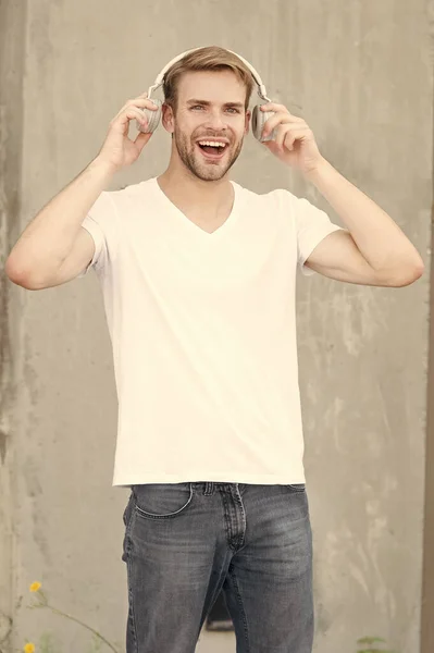 Good sound for happy experience. Happy man listen to music grey background. Handsome guy enjoy happy melody playing in headphones. Pleasure and joy. Fun and entertainment. Be happy and positive — Stock Photo, Image