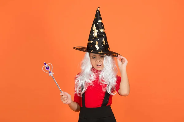 Happy halloween. smiling child in witch hat. kid hold magic wand. childhood happiness. teen girl ready to celebrate costume party. witchcraft and enchantment. believe in miracles — Stock Photo, Image