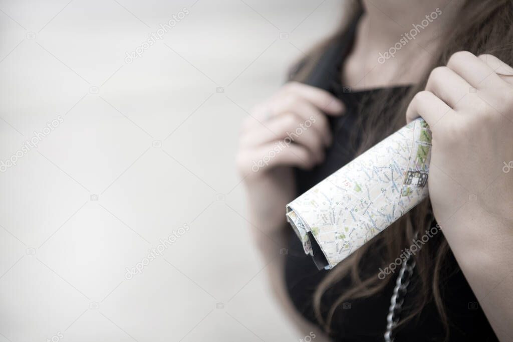 Navigation. Tourist used to use paper sheet map. Backpacker use paper map for navigation. Orienteering topographic map. Girl tourist exploring city. Woman urban architecture background copy space