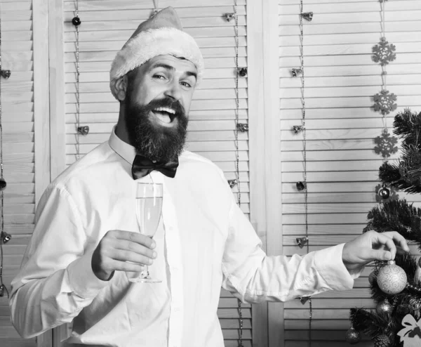 Papai Noel em chapéu com rosto alegre detém bola decorativa. — Fotografia de Stock
