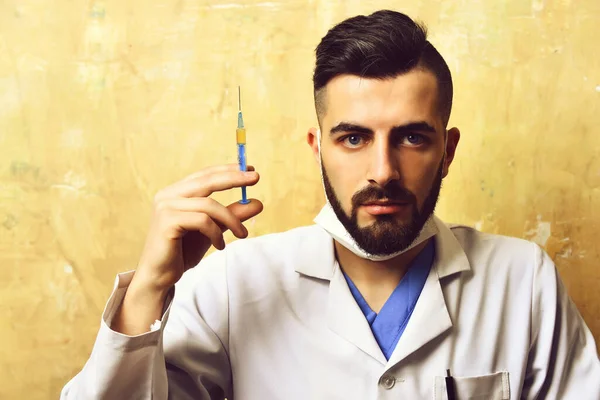 Doctor holds syringe with solution — Stock Photo, Image