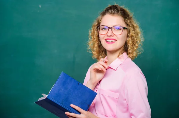 Teacher explain hard topic. Teacher best friend of learners. Pedagogue hold book and explaining information. Education concept. Woman school teacher in front of chalkboard. Passionate about knowledge