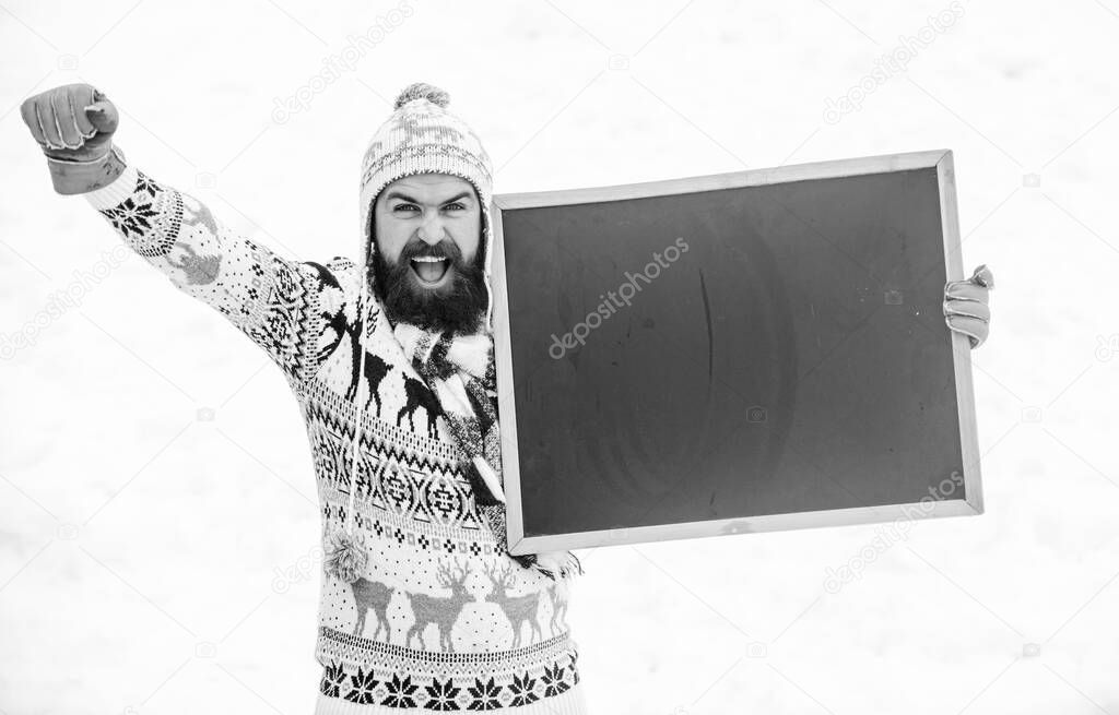final sales. ski and sledge. happy hipster with blackboard. bearded man in warm clothes. Happy new year. winter holiday. Party here. man advertising board. Copy space. winter season. Christmas sales