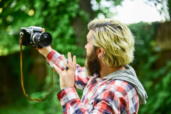 Photography in modern life. Use camera. Creating content for blog. Bearded man hipster taking photo. Hobby and professional occupation. Photographer and vintage camera. Man with retro camera — Stock Photo, Image