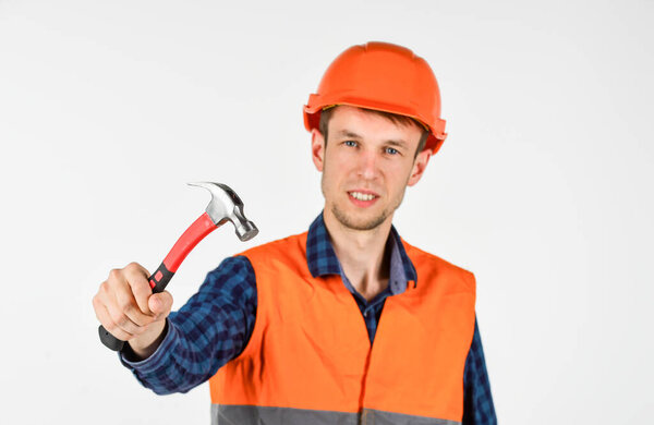 repairman in uniform. man work with hammer. real construction worker in helmet. carpenter ready to work. building tool repair equipment. young worker is engineer assistant. fixing everything