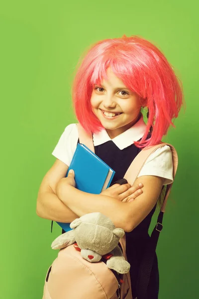 Girl with backpack, book and toy. Schoolgirl with pink wig — Stock Photo, Image