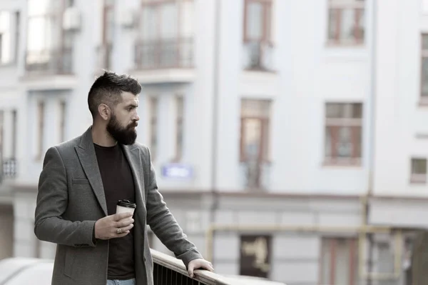 One more sip of coffee. Enjoying coffee on the go. Businessman well groomed appearance enjoy coffee break out of business center. Relax and recharge. Man bearded hipster drinking coffee paper cup — Stock Photo, Image