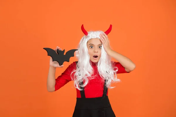 Scared child in imp horn costume and white hair wig to halloween with funny bat, halloween party — Stock Photo, Image