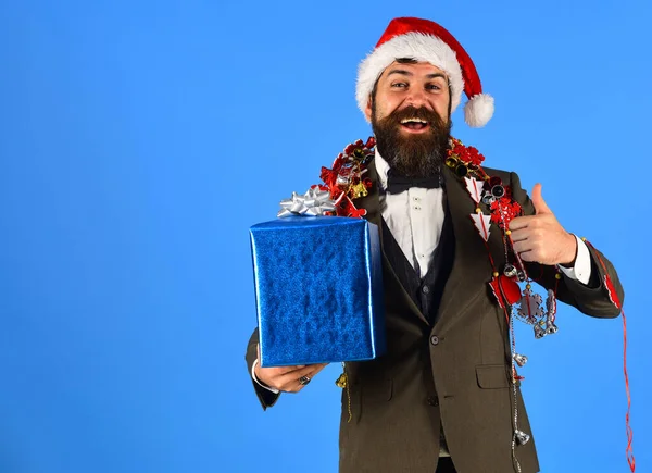 Geschäftsmann mit fröhlichem Gesicht hält Geschenkbox mit Daumen hoch. — Stockfoto