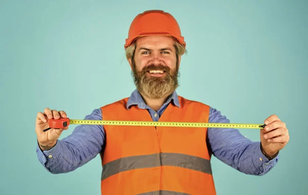 Safety Engineer Measure Acceptable Parameters. Builder with tape measure. Custom made furniture. Worker use tape measure. Size concept. Hipster in hard hat. Make measurements apartment renovation — Stock Photo, Image