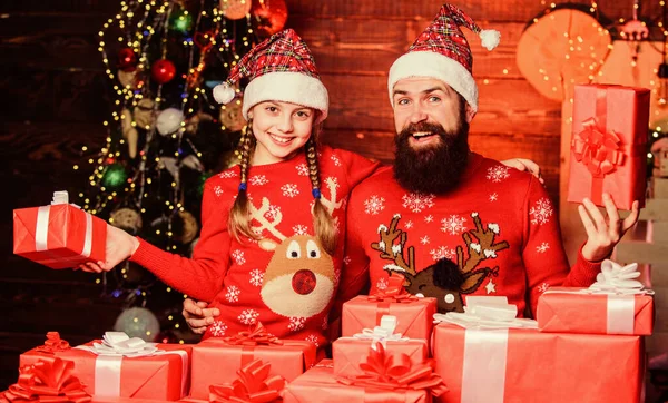 Dad and child opening christmas gifts. Happy holidays. Favorite childhood memories of christmas. Gifts for nearest. Father bearded man and daughter near christmas tree. Spend time with your family