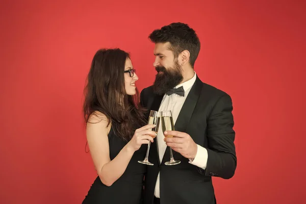 Toast to love. Couple in love drink champagne. Sexy woman and bearded man raise glasses. Happy family celebrate Valentines day. Drink to love. Romantic relationship. Love always